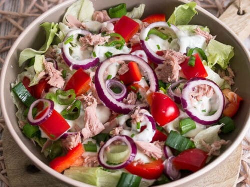 Schüssel mit Thunfischsalat mit Kopfsalat, roten Zwiebeln, Paprika, grünen Frühlingszwiebeln und Joghurt-Dressing.