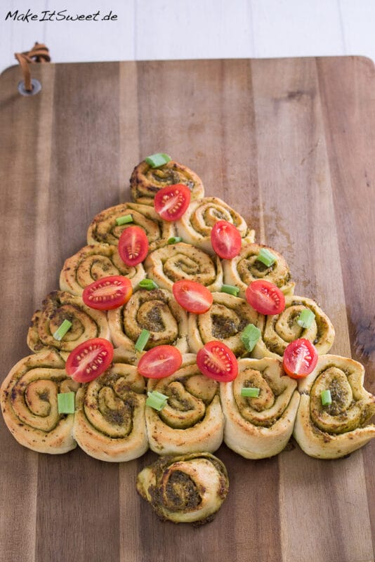 Pesto Tannenbaum - herzhaftes Fingerfood Weihnachten 2 Ein weihnachtlicher Pesto-Tannenbaum aus herzhaften Pinwheel-Rollen, dekoriert mit halbierten Kirschtomaten und gehackten grünen Zwiebeln - perfektes Fingerfood Weihnachten für Ihren Festtagstisch.